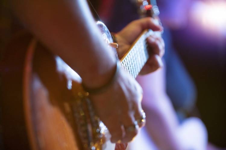 person playing guitar on stage